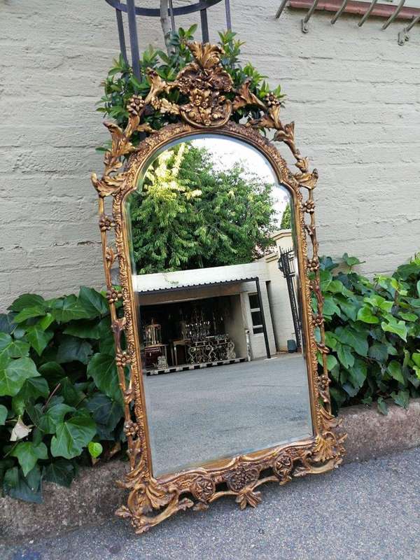 An Ornately Carved and Giltwood Mirror ND