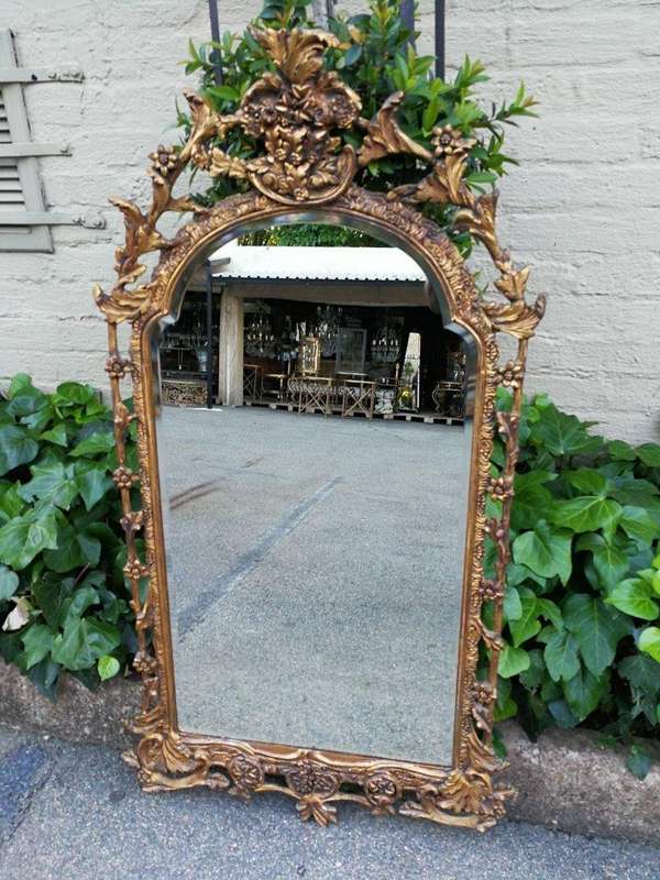 An Ornately Carved and Giltwood Mirror ND