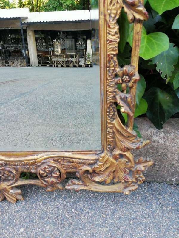 An Ornately Carved and Giltwood Mirror ND