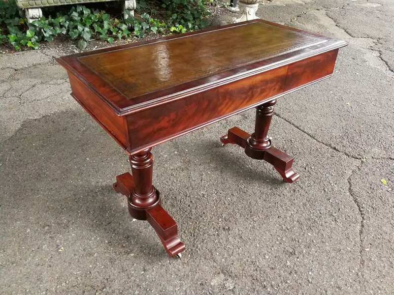 A 19th Century Flamed Mahogany Sofa / Writing Table with Leather and Hand Tooled Top On Cators