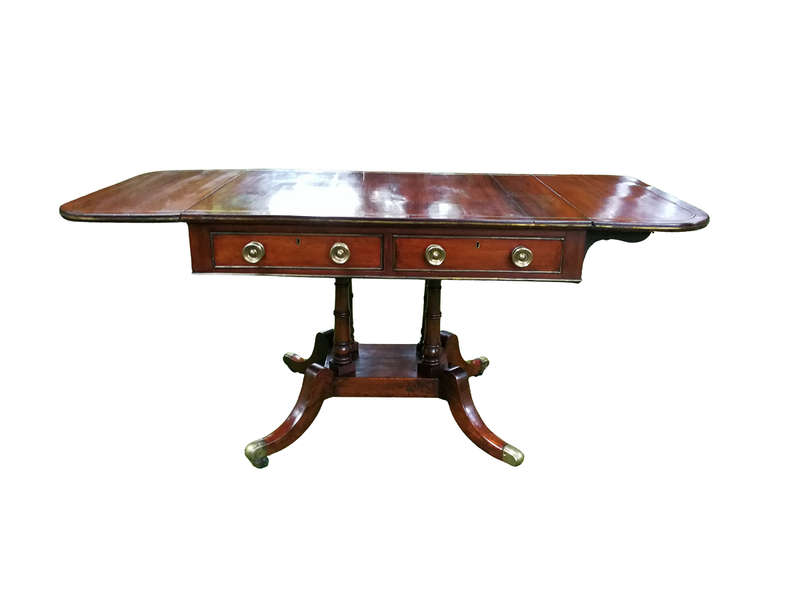 A Regency Mahogany Sofa Table On Brass Castors With Brass