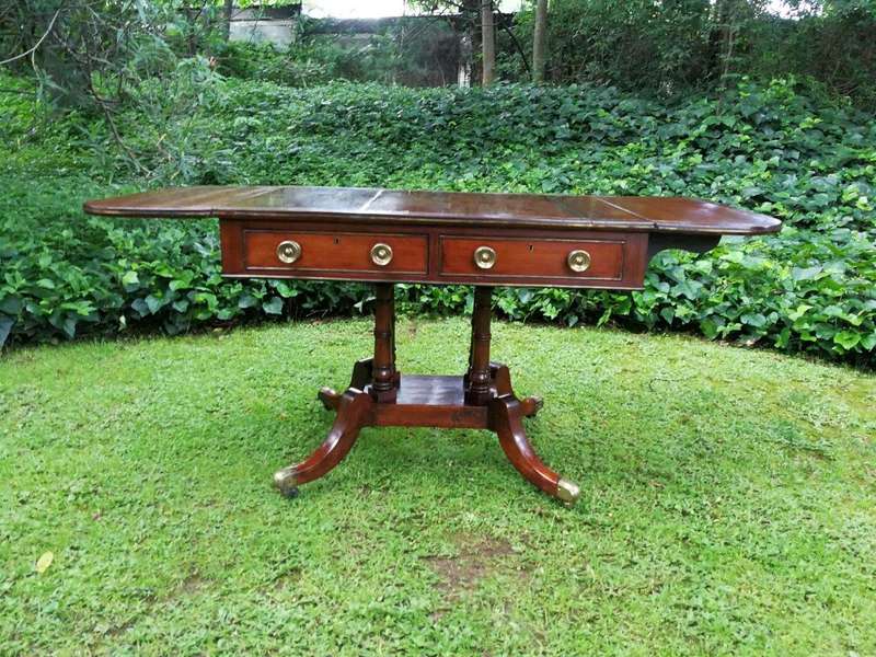A Regency Mahogany Sofa Table On Brass Castors With Brass