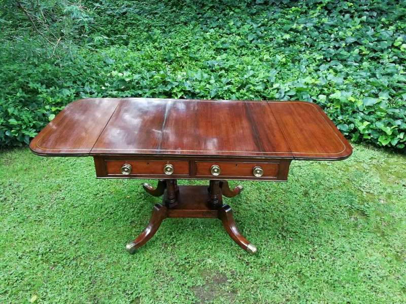 A Regency Mahogany Sofa Table On Brass Castors With Brass