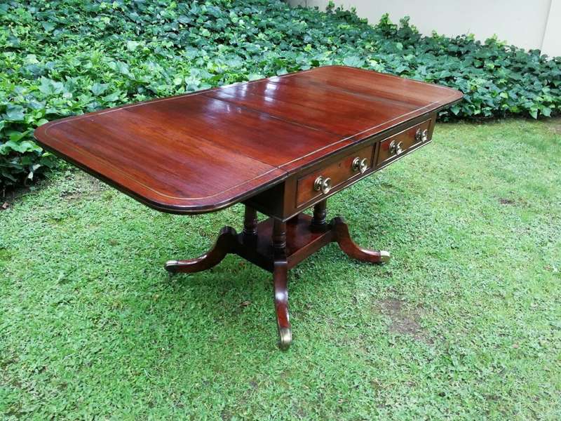 A Regency Mahogany Sofa Table On Brass Castors With Brass