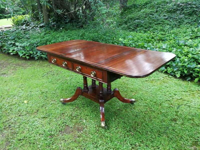 A Regency Mahogany Sofa Table On Brass Castors With Brass