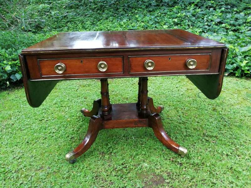 A Regency Mahogany Sofa Table On Brass Castors With Brass