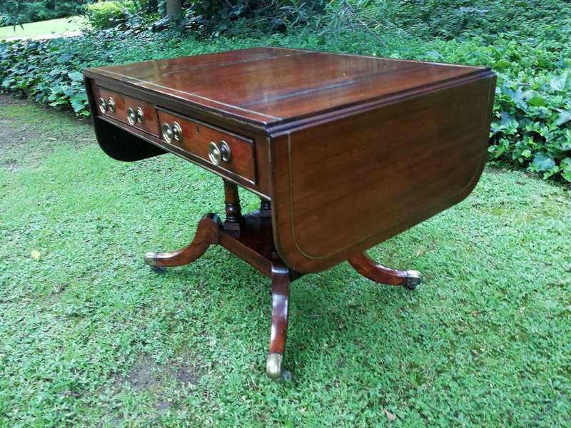 A Regency Mahogany Sofa Table On Brass Castors With Brass