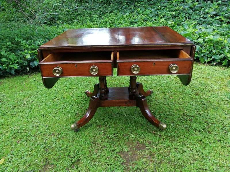 A Regency Mahogany Sofa Table On Brass Castors With Brass