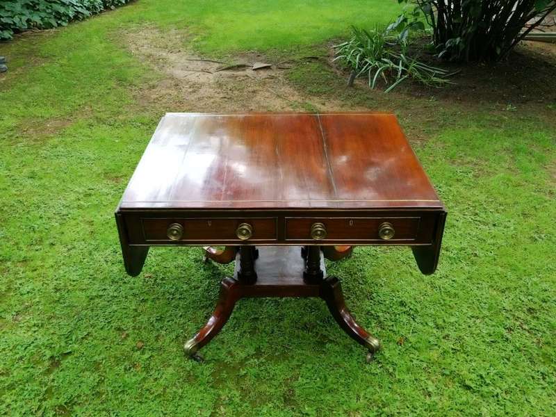 A Regency Mahogany Sofa Table On Brass Castors With Brass