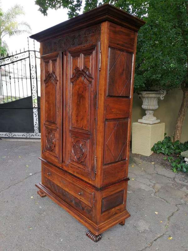 An 18th Century French Walnut Port Armoire Of Large Proportions And With Cast Iron Hinges