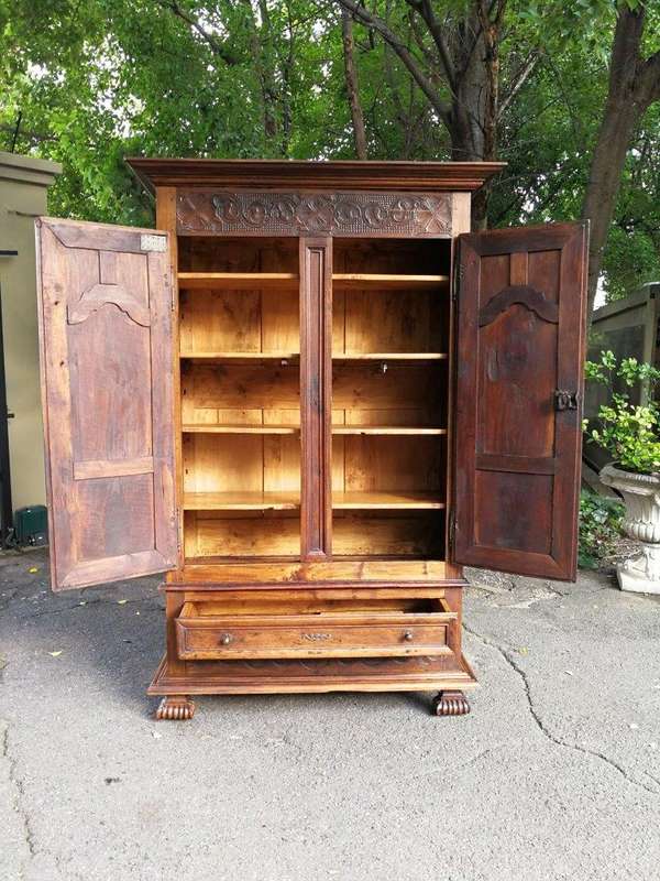 An 18th Century French Walnut Port Armoire Of Large Proportions And With Cast Iron Hinges