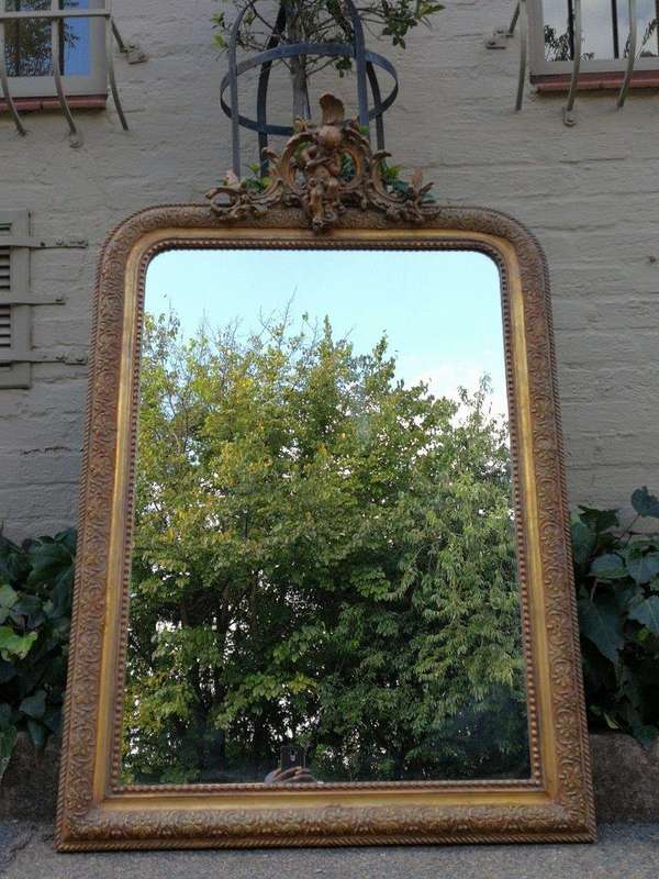 A French Gilt And Gesso Rococo Style Mirror, With Putti