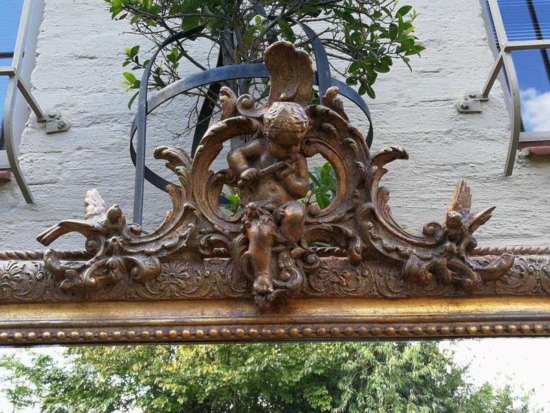 A French Gilt And Gesso Rococo Style Mirror, With Putti