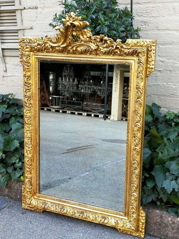 A Heavily Carved and Gilded Mirror ND