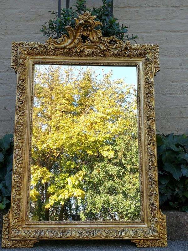 A Heavily Carved and Gilded Mirror ND
