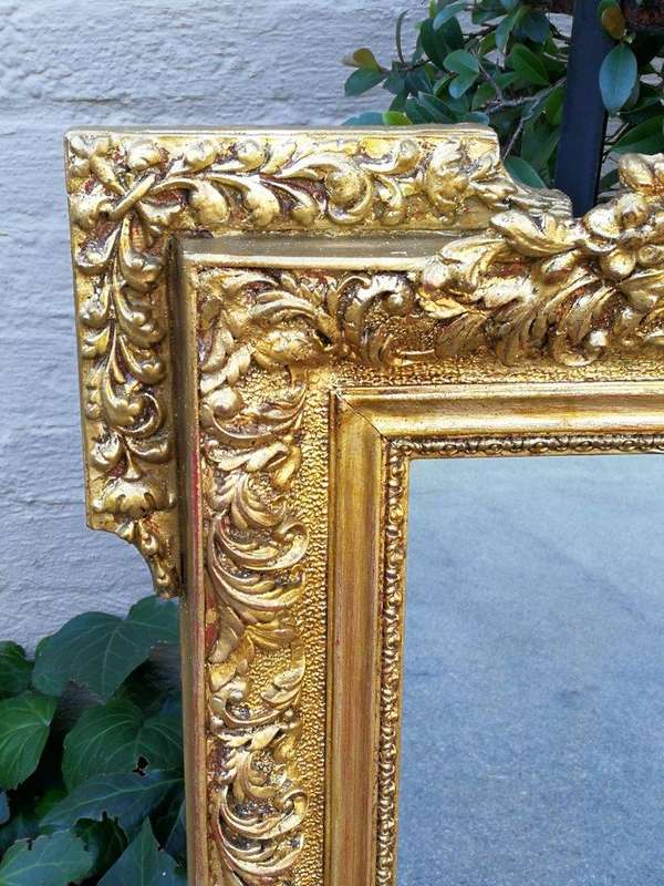 A Heavily Carved and Gilded Mirror ND