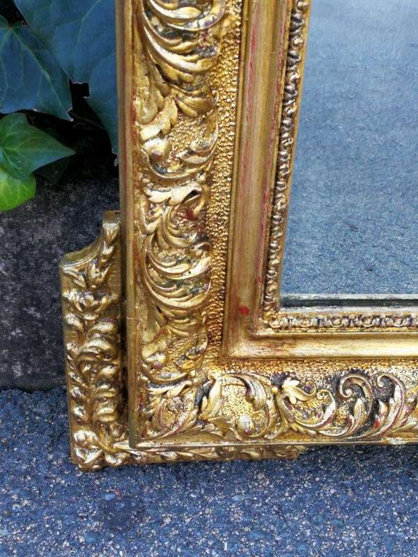 A Heavily Carved and Gilded Mirror ND
