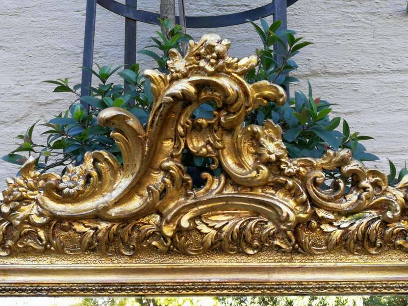 A Heavily Carved and Gilded Mirror ND
