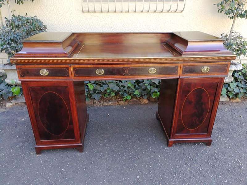 A Late Regency Inlaid Mahogany and Rosewood Pedestal Sideboard, fitted with original oval foliate...