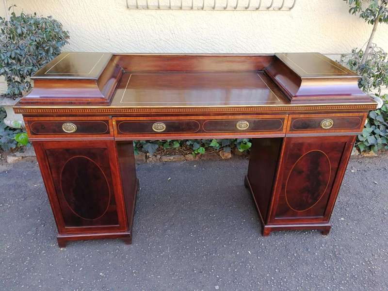 A Late Regency Inlaid Mahogany and Rosewood Pedestal Sideboard, fitted with original oval foliate...