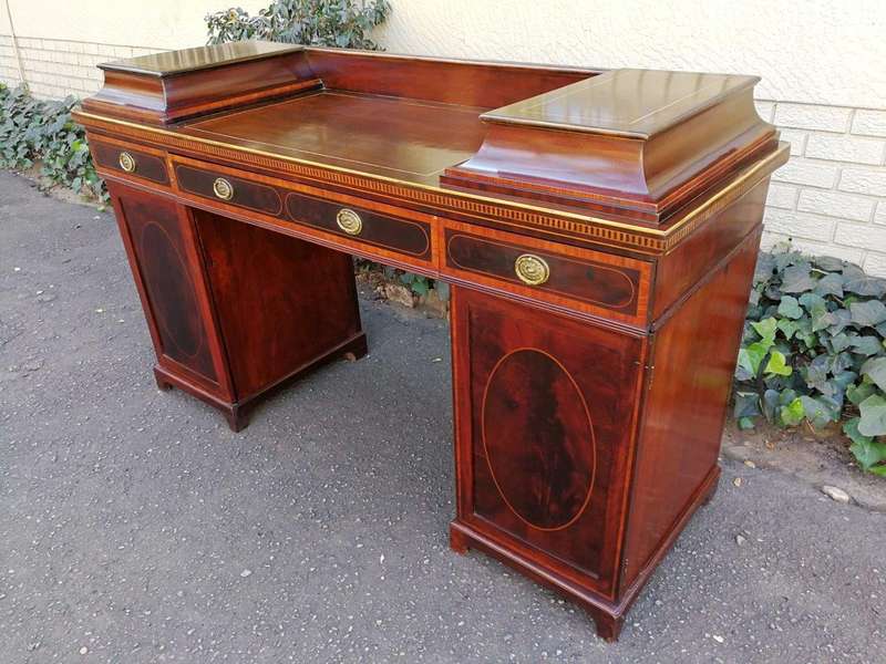 A Late Regency Inlaid Mahogany and Rosewood Pedestal Sideboard, fitted with original oval foliate...