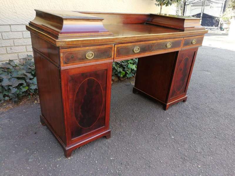 A Late Regency Inlaid Mahogany and Rosewood Pedestal Sideboard, fitted with original oval foliate...