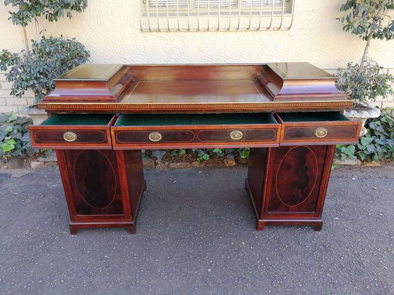 A Late Regency Inlaid Mahogany and Rosewood Pedestal Sideboard, fitted with original oval foliate...