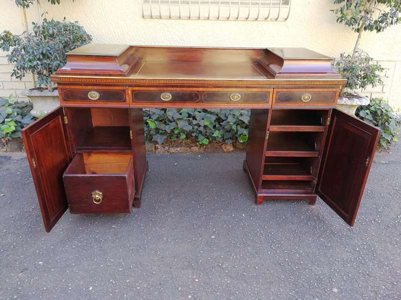 A Late Regency Inlaid Mahogany and Rosewood Pedestal Sideboard, fitted with original oval foliate...