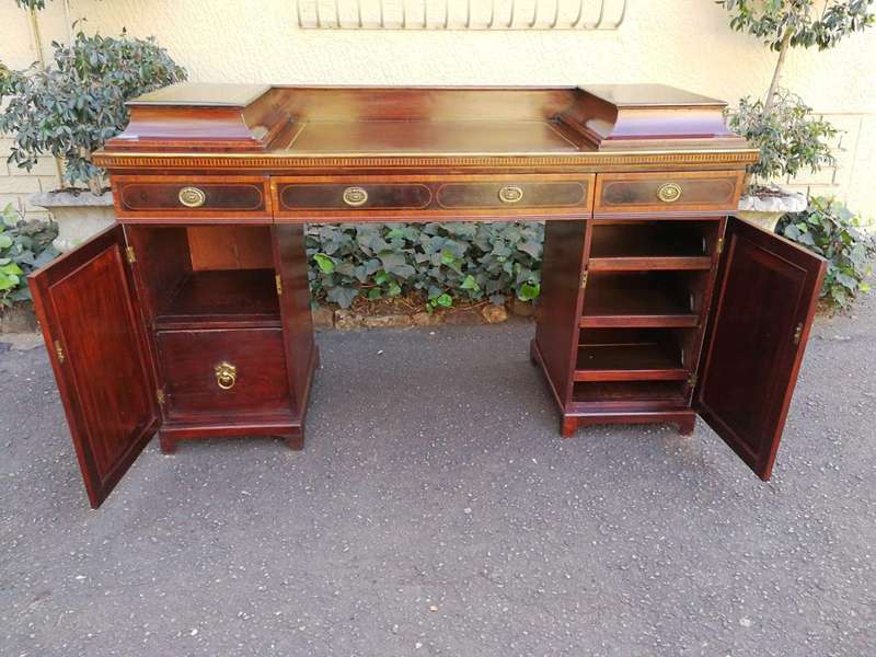 A Late Regency Inlaid Mahogany and Rosewood Pedestal Sideboard, fitted with original oval foliate...
