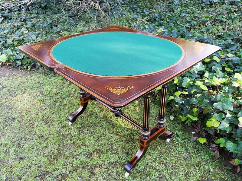 A Napoleon III Inlaid Ebony, Walnut and Ormolu Card / Stretcher Table