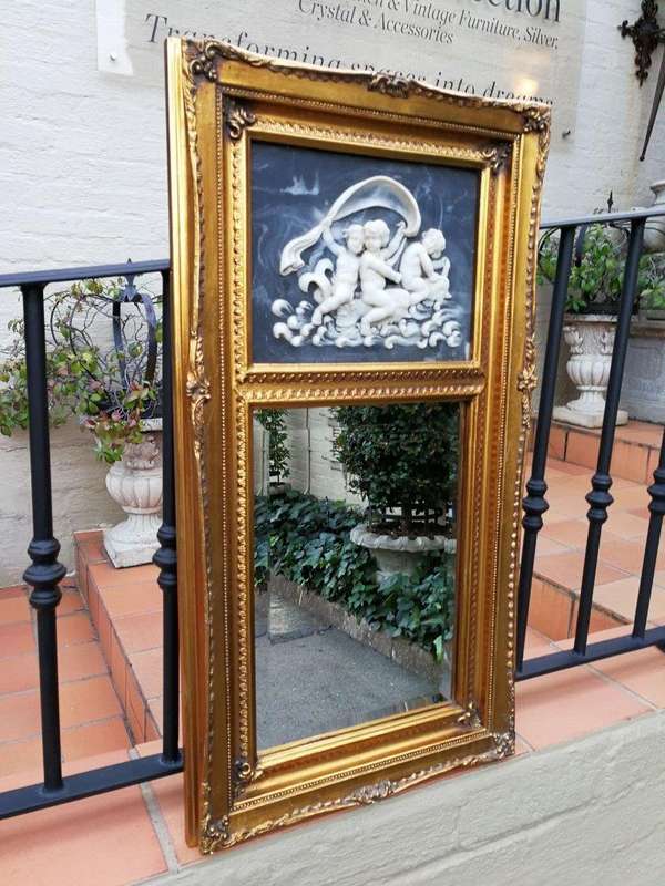 A Circa 1900 French Louis XVI Style Wooden Gilt-painted and Bevelled Mirror with a Carved Black a...