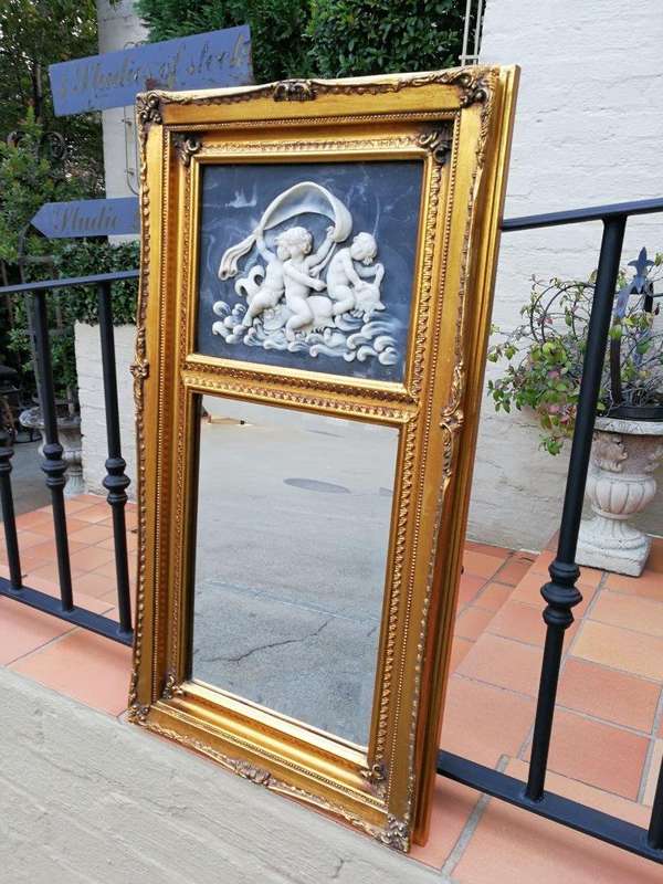 A Circa 1900 French Louis XVI Style Wooden Gilt-painted and Bevelled Mirror with a Carved Black a...