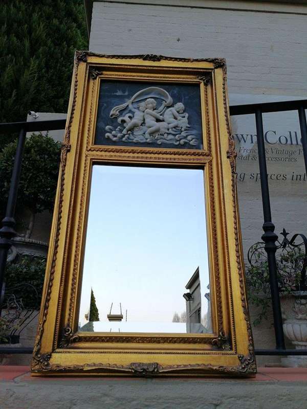 A Circa 1900 French Louis XVI Style Wooden Gilt-painted and Bevelled Mirror with a Carved Black a...