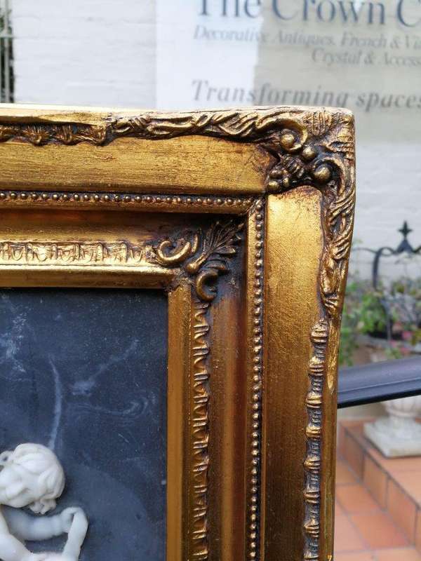 A Circa 1900 French Louis XVI Style Wooden Gilt-painted and Bevelled Mirror with a Carved Black a...