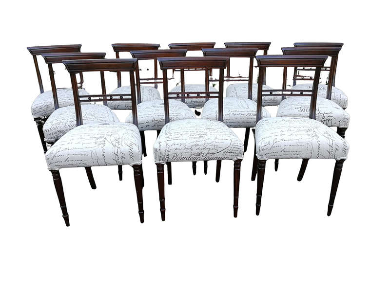 A Set of Twelve Regency Mahogany Dining Chairs upholstered in an exclusive and custom-made hand p...