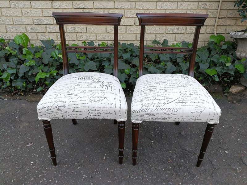 A Set of Twelve Regency Mahogany Dining Chairs upholstered in an exclusive and custom-made hand p...