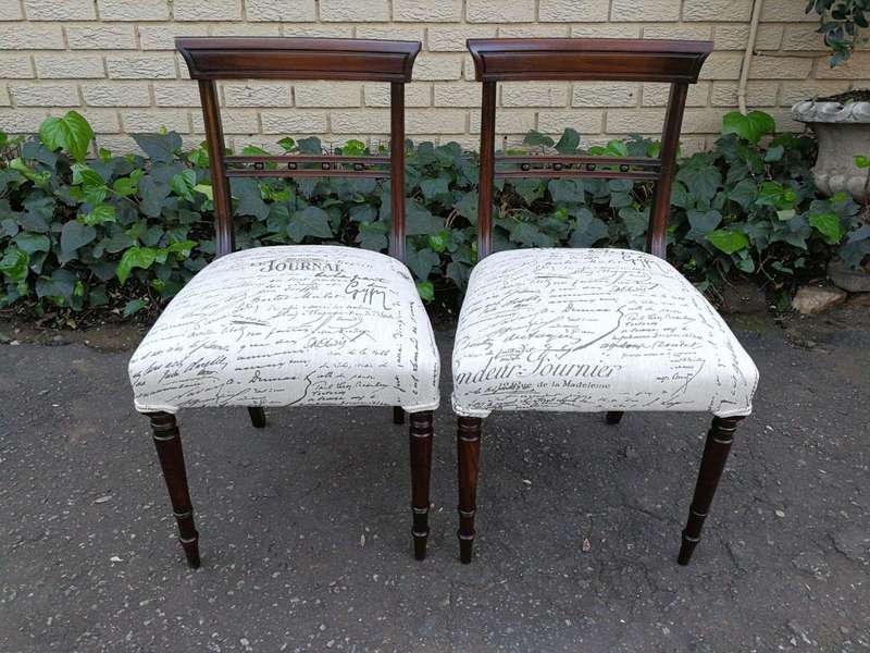 A Set of Twelve Regency Mahogany Dining Chairs upholstered in an exclusive and custom-made hand p...