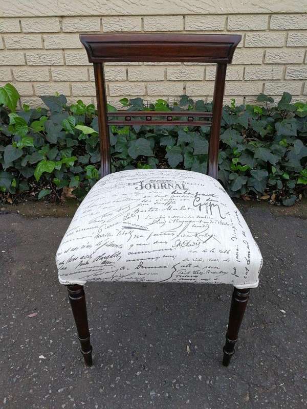 A Set of Twelve Regency Mahogany Dining Chairs upholstered in an exclusive and custom-made hand p...
