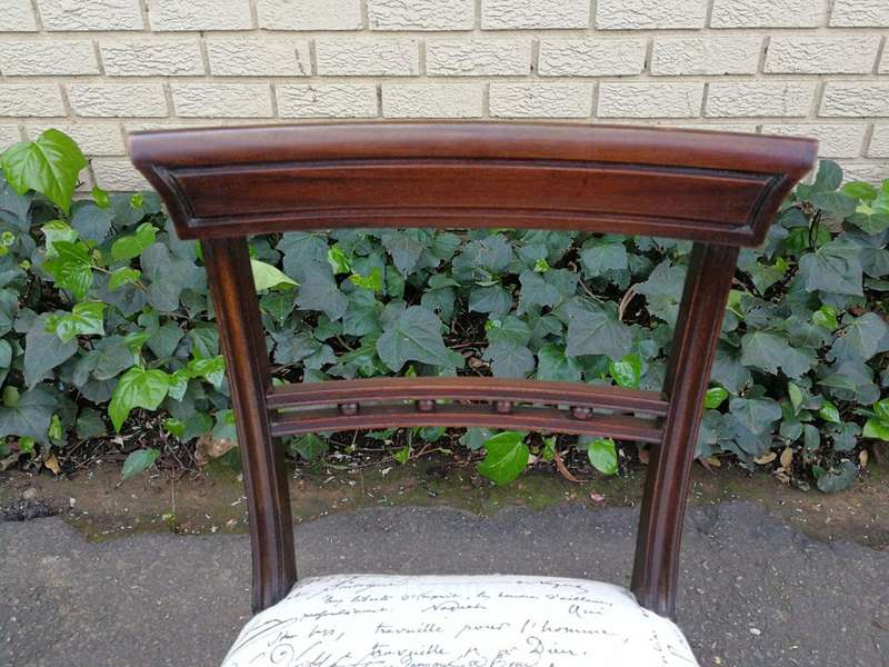 A Set of Twelve Regency Mahogany Dining Chairs upholstered in an exclusive and custom-made hand p...