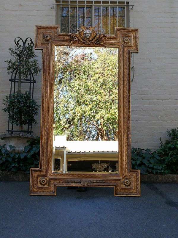 A Large Ornately Carved and Gilt Wood Bevelled Mirror