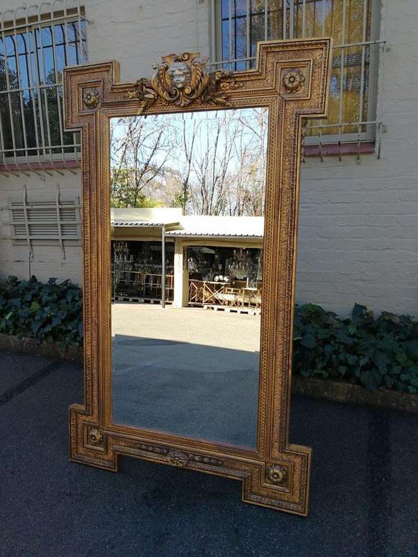 A Large Ornately Carved and Gilt Wood Bevelled Mirror