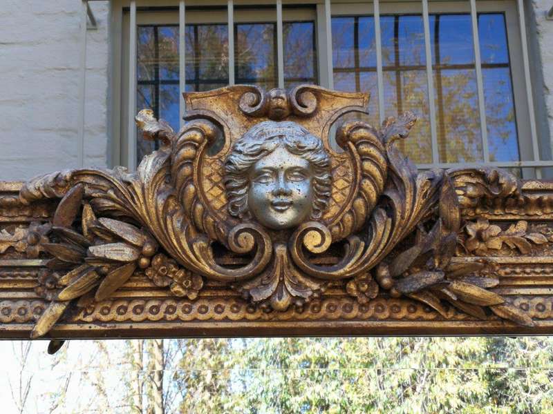 A Large Ornately Carved and Gilt Wood Bevelled Mirror