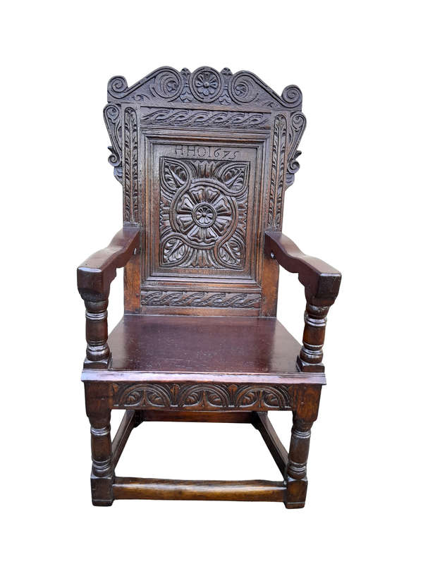 An 18th / 19th Century Carved Oak Wainscot Armchair the date and initials H. HO