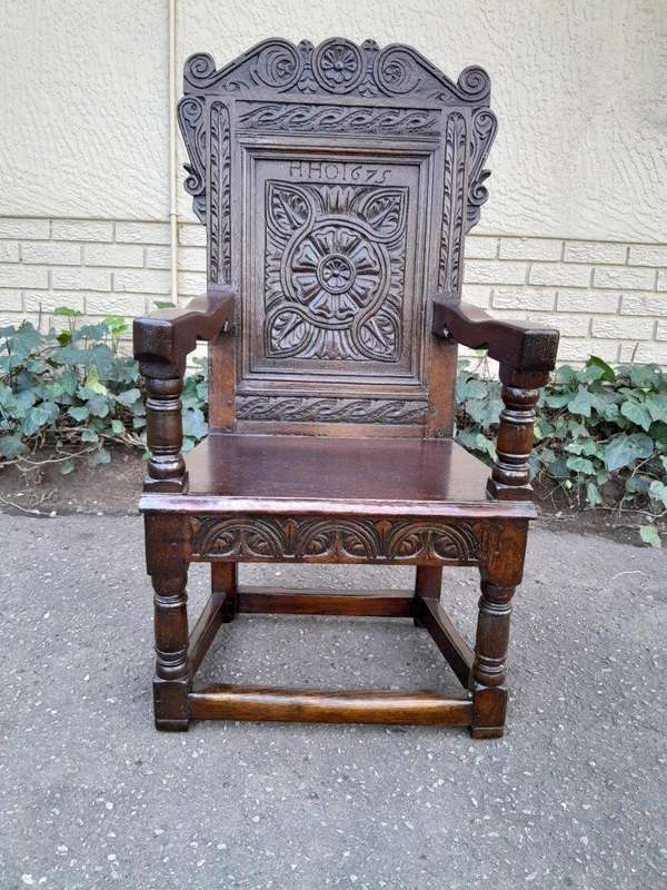 An 18th / 19th Century Carved Oak Wainscot Armchair the date and initials H. HO