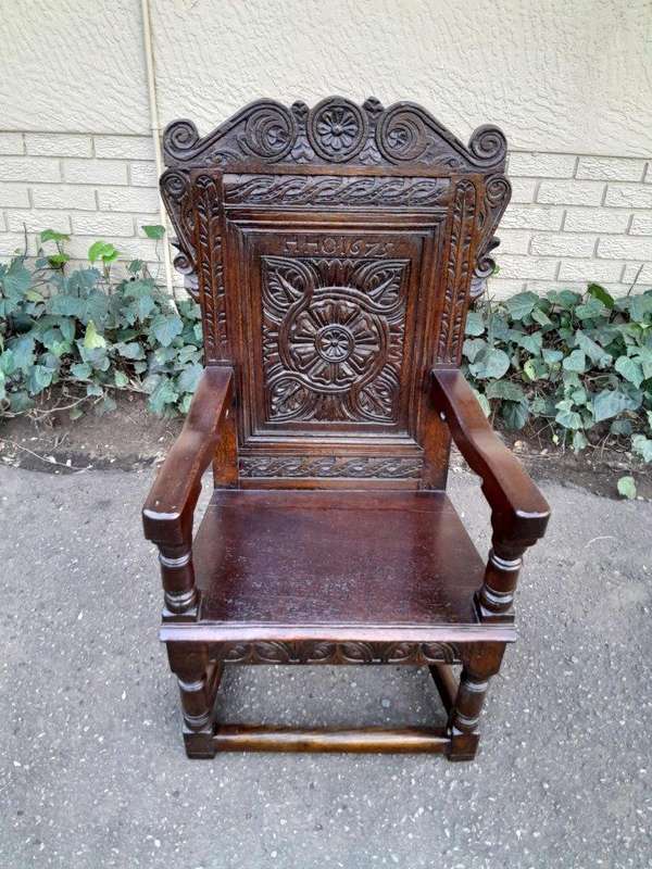 An 18th / 19th Century Carved Oak Wainscot Armchair the date and initials H. HO