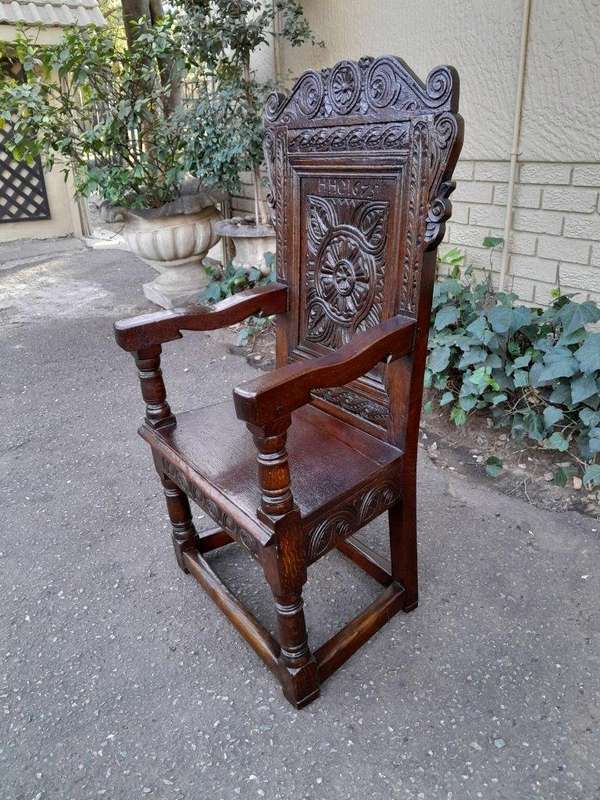 An 18th / 19th Century Carved Oak Wainscot Armchair the date and initials H. HO