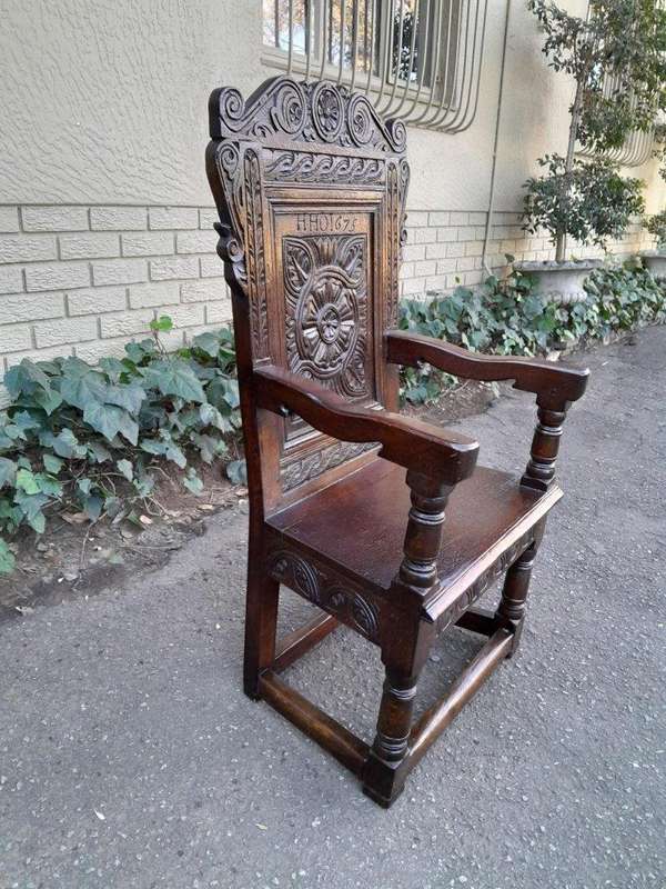 An 18th / 19th Century Carved Oak Wainscot Armchair the date and initials H. HO
