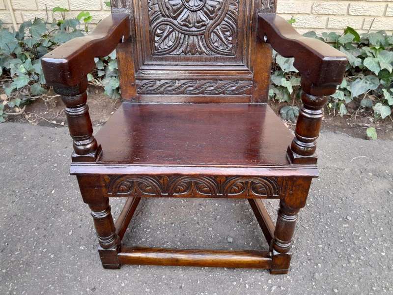 An 18th / 19th Century Carved Oak Wainscot Armchair the date and initials H. HO