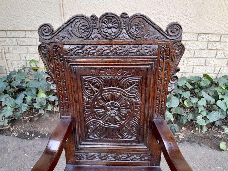 An 18th / 19th Century Carved Oak Wainscot Armchair the date and initials H. HO