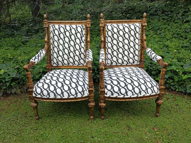 A Pair of French Style Ornately Carved and Gilded Armchairs ND